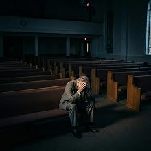 Dark, atmospheric interior shots of what appears to be a church or chapel with wooden pews. Moody lighting creates dramatic shadows throughout the space.